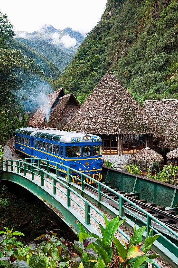 A Perurail train arriving in the town of Agua Calientes near Macchu Pichu, Peru
