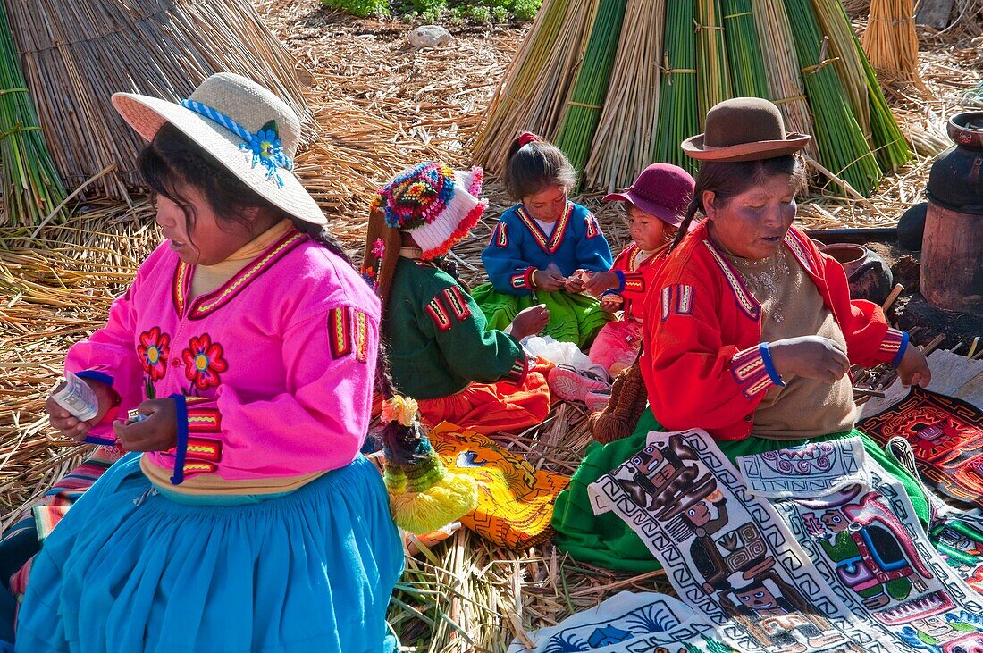 Villagers in traditional dress on the floating Islands in Lake Titicaca, Peru, South America