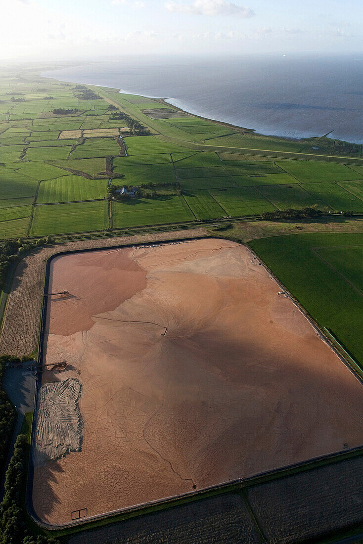 Aerial shot of an industrial sludge basin, North Sea coast, Lower Saxony, Germany