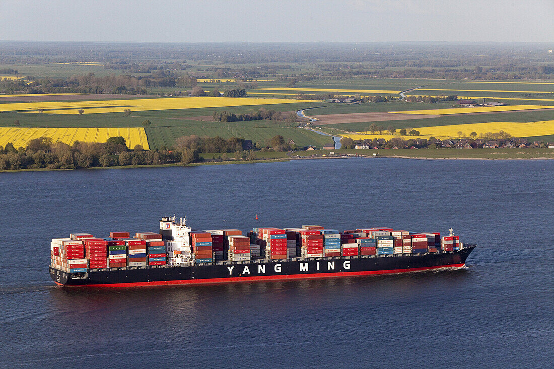 Aerial view of a Taiwanese container ship on the River Elbe, fields in the background, Lower Saxony, Germany