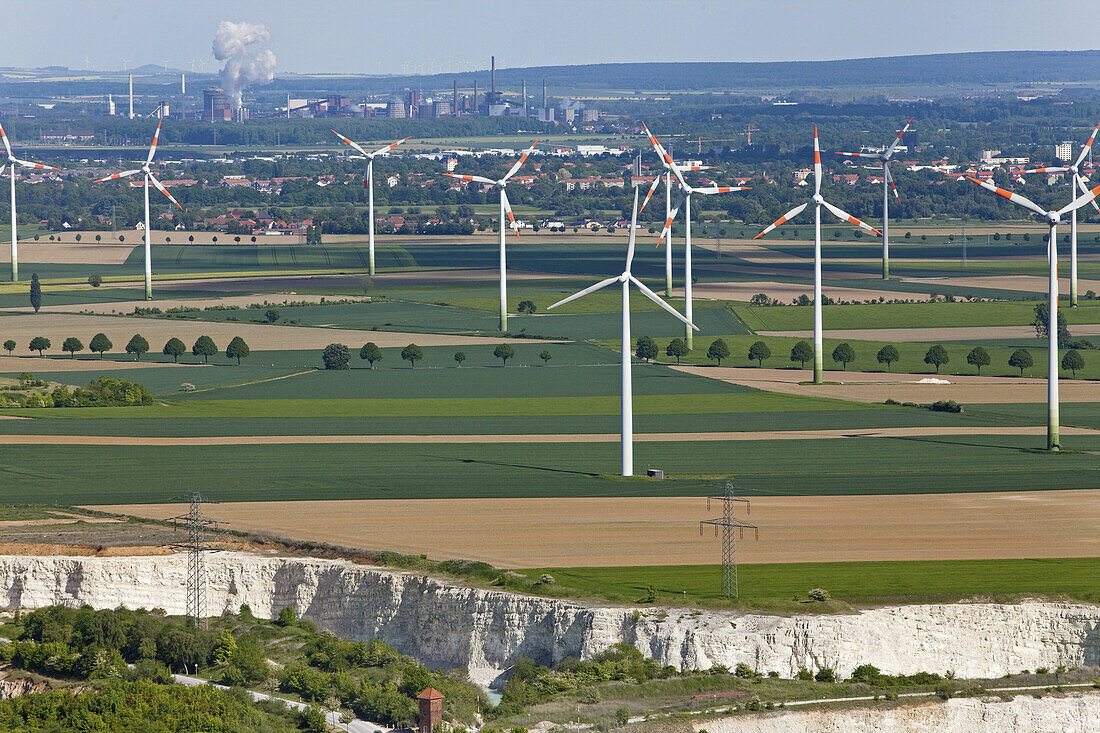 Aerial view of a wind farm, turbines in an agricultural landscape, lime pit in the foreground, steelworks in the background, Salzgitter, Lower Saxony, Germany