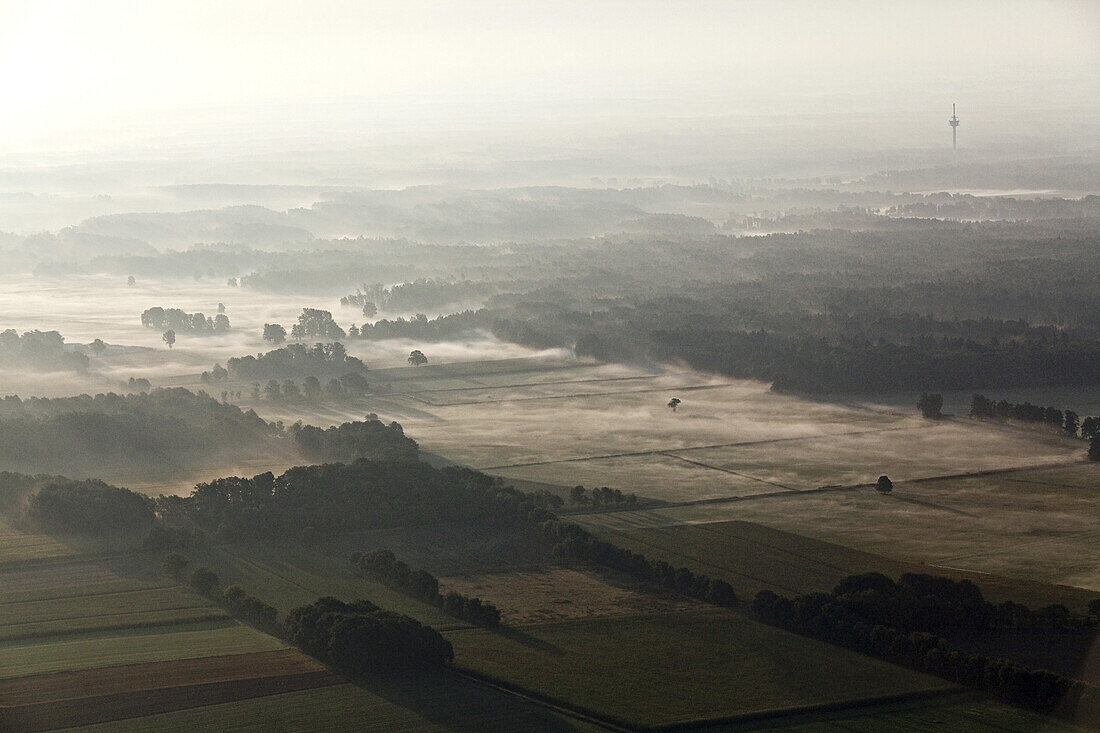 Aerial of flat, North German landscape in the morning mist, Lower Saxony, Germany