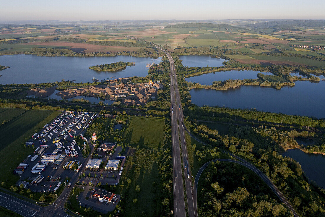 Aerial of Autobahn A7 crossing shingle ponds near Northeim, Lower Saxony, Germany