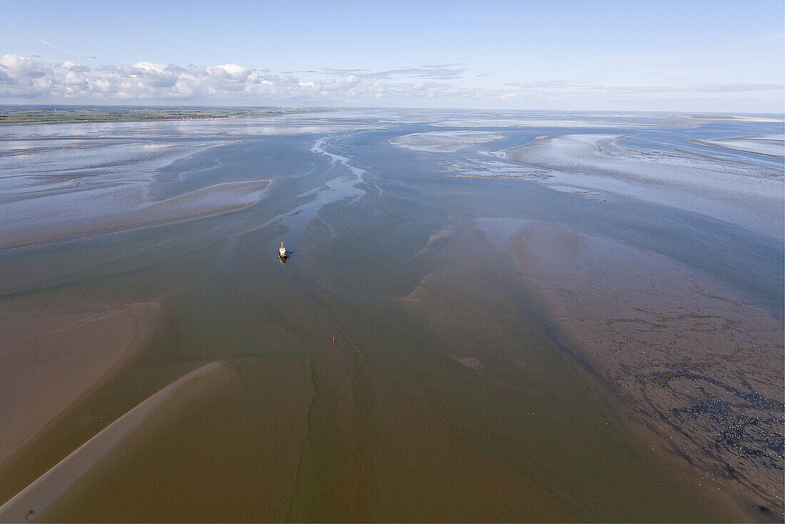 Aerial of tidal mudflats with stranded boat, Wadden Sea, Lower Saxony, Germany