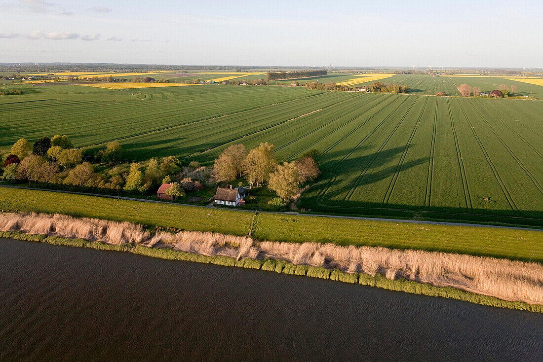 Aerial shot of fields and Stoer river near Wewelsfleth, Schleswig Holstein, Germany