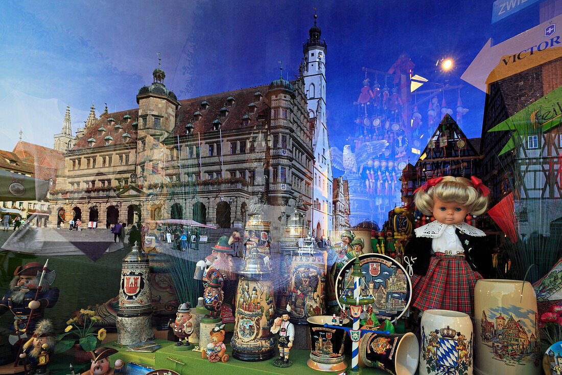 Window of a souvenir shop reflecting the town hall, Rothenburg ob der Tauber, Tauber valley, Romantic Road, Franconia, Bavaria, Germany