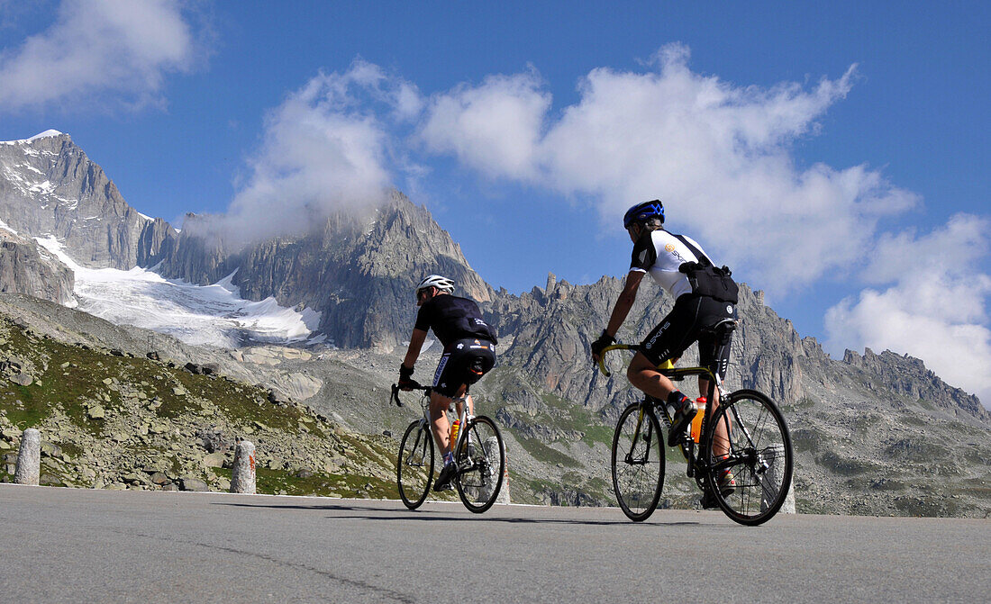 Two cyclists at Furka Pass, Canton of Uri, Switzerland