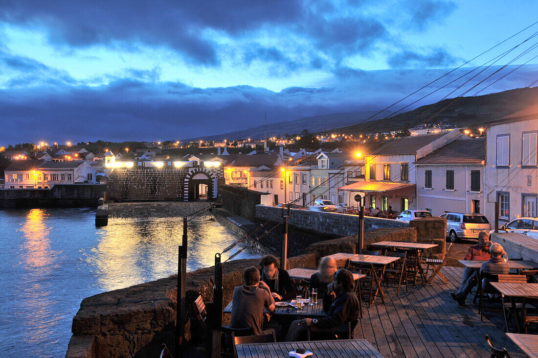 Menschen auf einer Restaurantterrasse am Abend, Portao do Porta Pim, Horta, Insel Faial, Azoren, Portugal, Europa