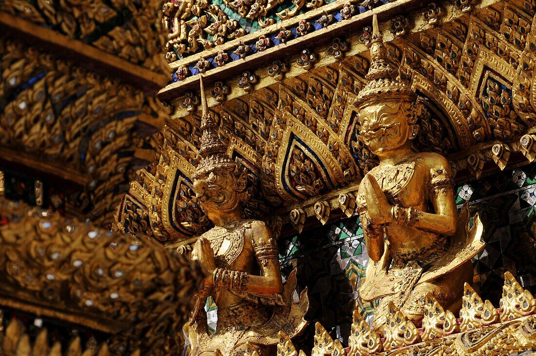 Guardian mythical demons supporting golden chedi, Grand Palace, Bangkok, Thailand