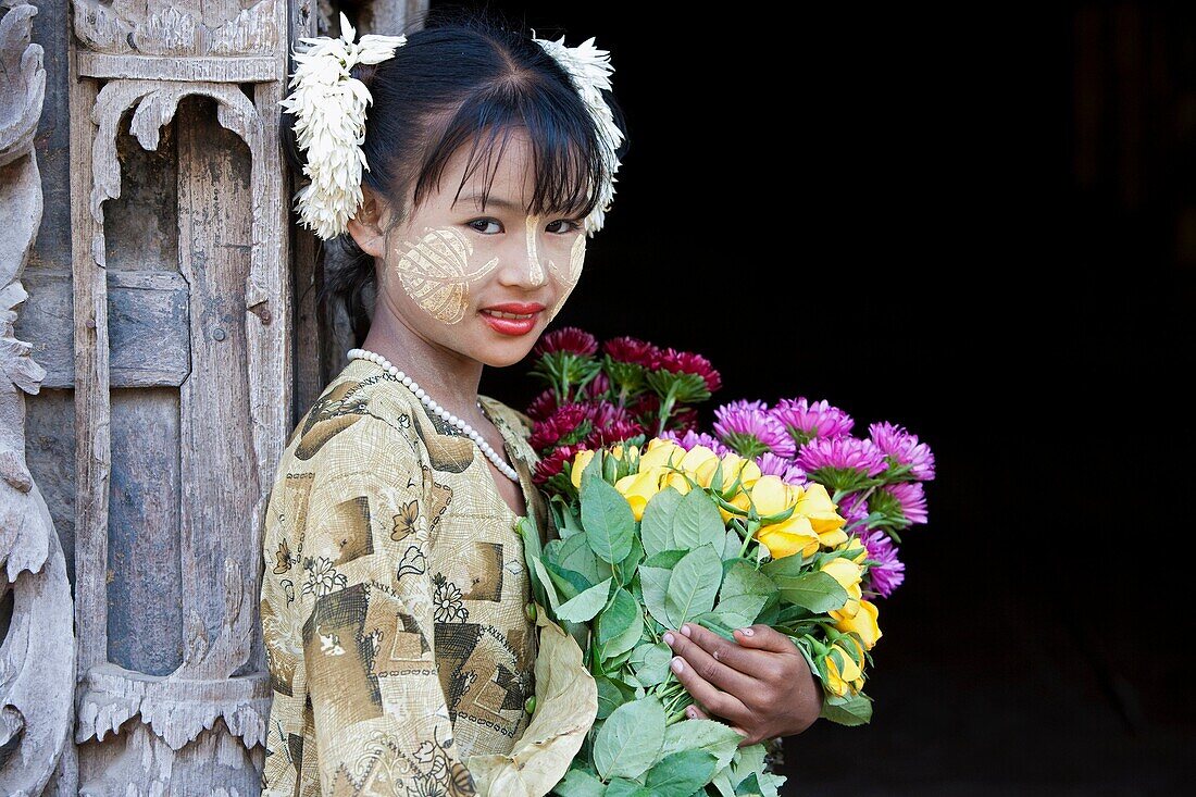 Myanmar, girl with traditional thanakha, a burmese sun cream favoured by woman and girls as a skin or anti- wrinkle cream.