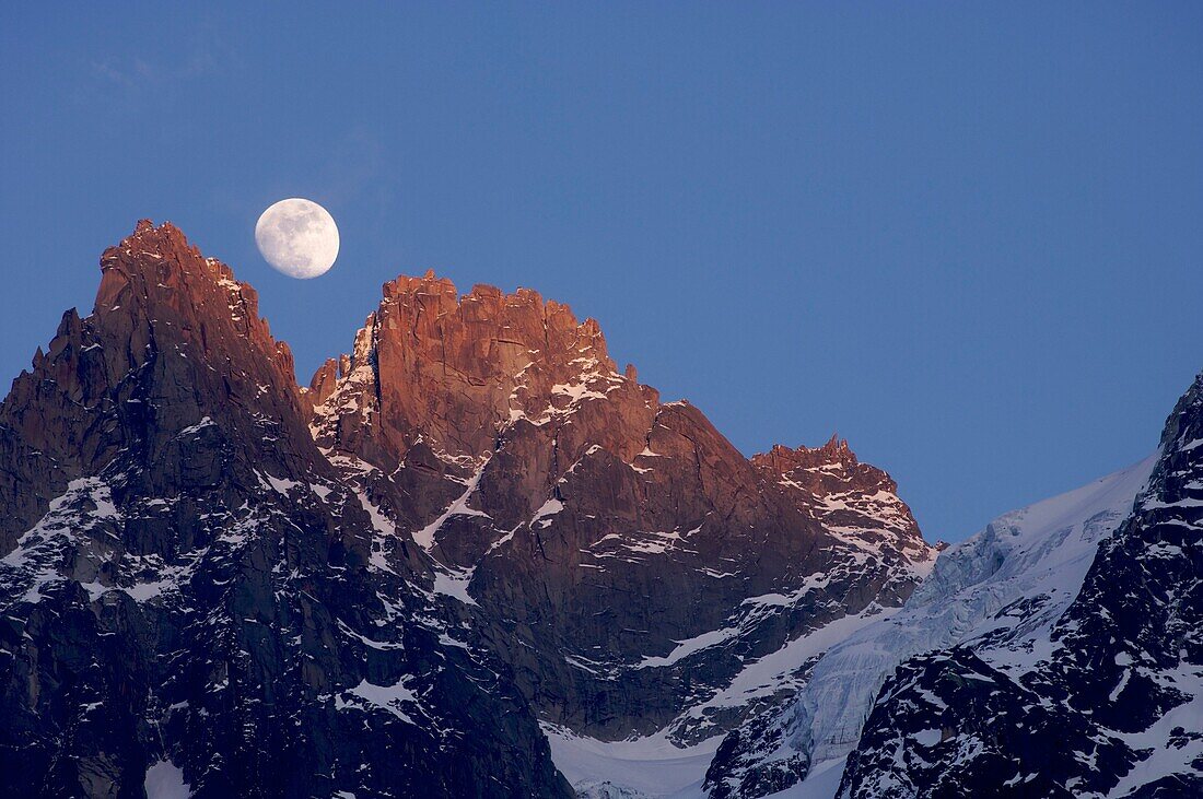 output moon in a warm evening in the hands of chamonix, alps, france