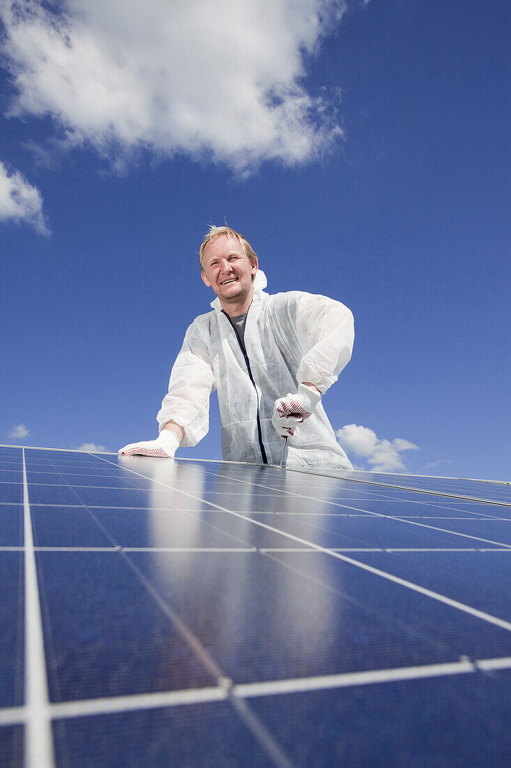 Technician installing a photovoltaic power plant, Hamburg, Germany