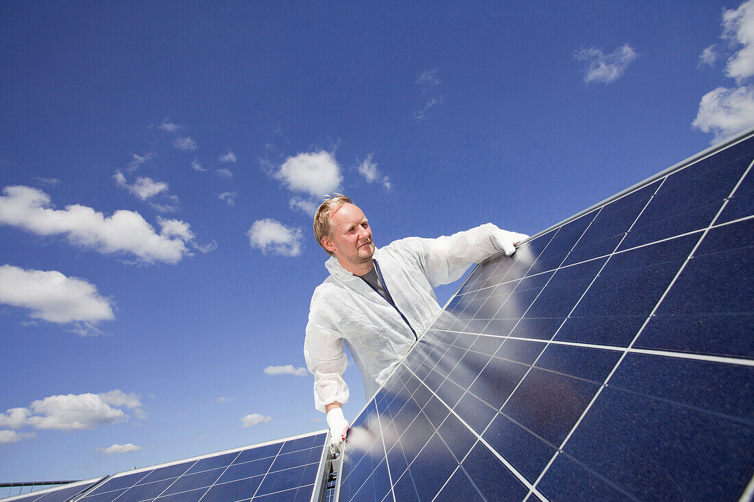 Technician installing a photovoltaic power plant, Hamburg, Germany