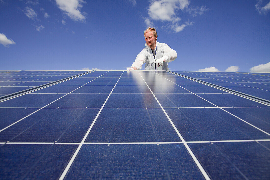 Technician installing a photovoltaic power plant, Hamburg, Germany