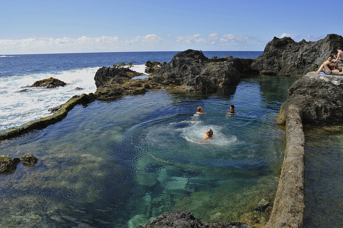Three women bathing in a natural pool at Garachico, Northwest Tenerife, Spain