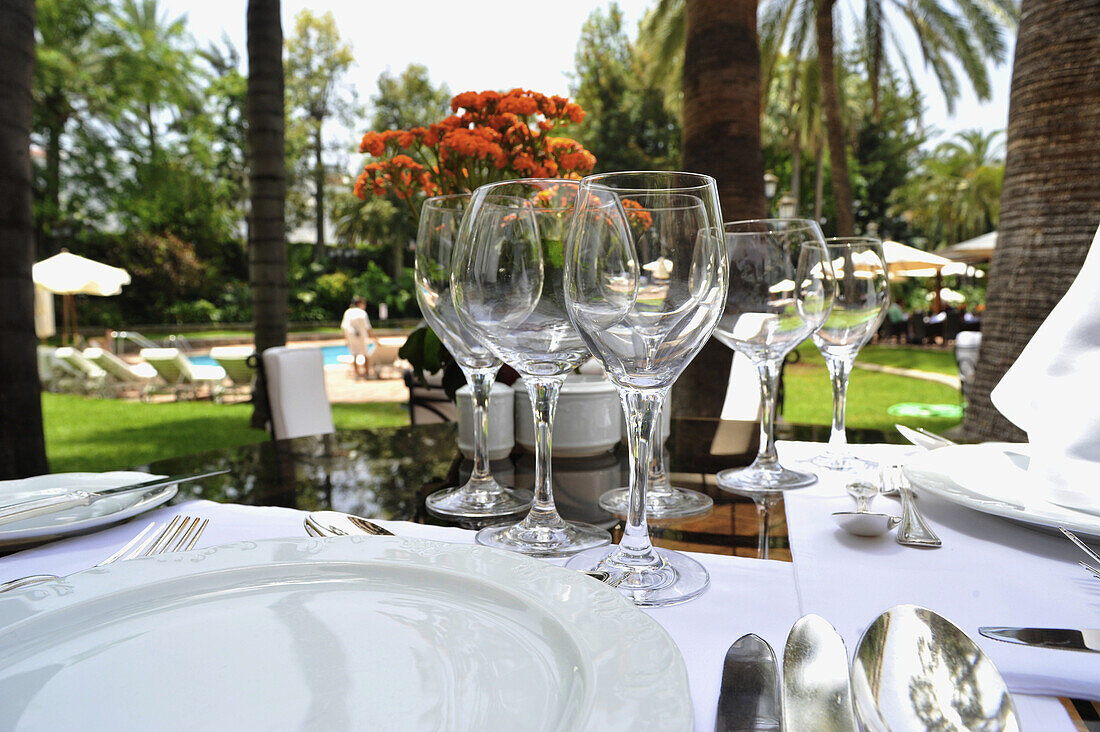 Table setting with wine glasses in the pool restaurant at Hotel Botanico,  Puerto de la Cruz, Tenerife, Canary Islands, Spain