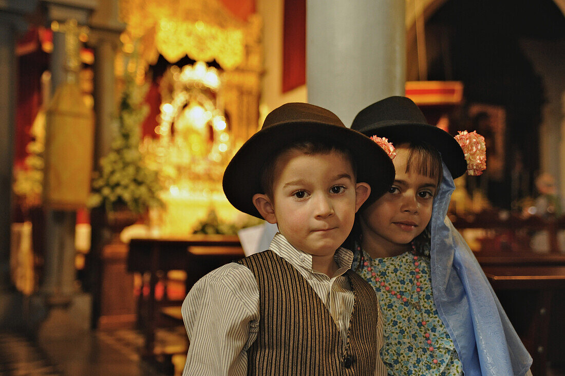 Boy and girl in canrian traditional costumes in the church at Los Realejos, Romeria, Tenerife, Canary Islands, Spain
