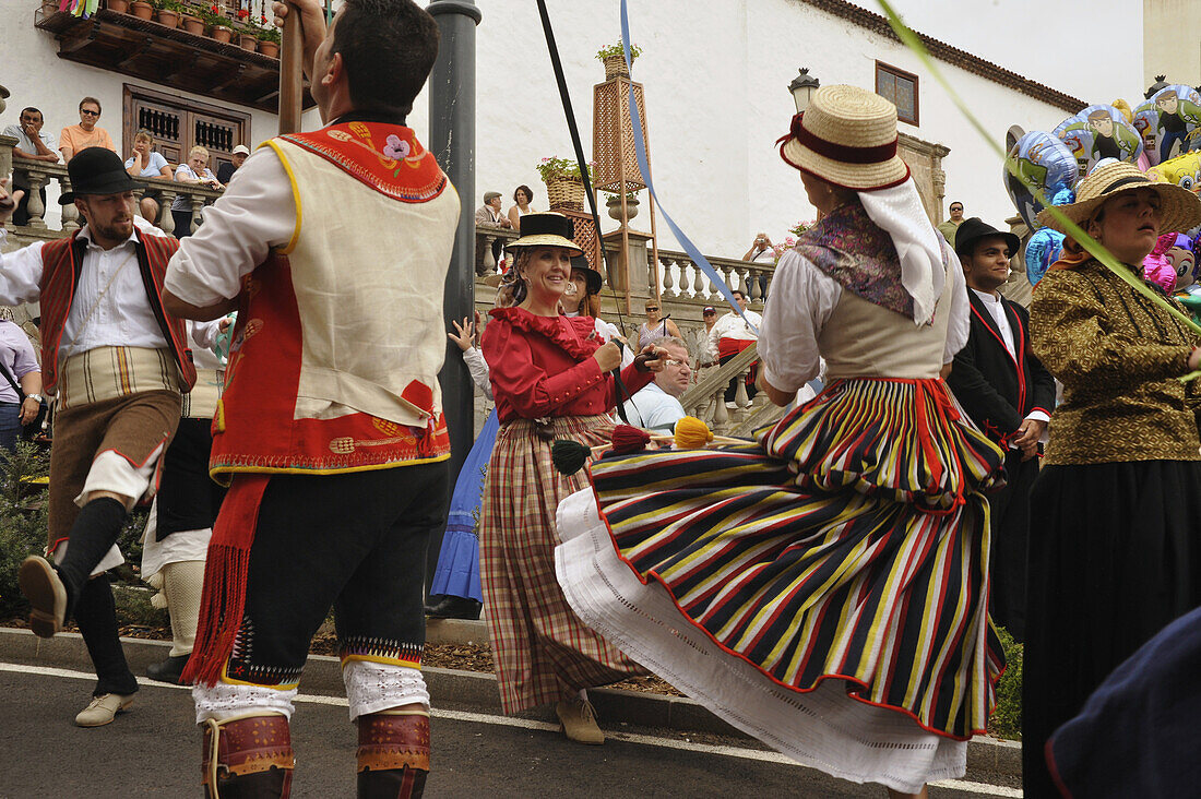 Dancing group of women and man in canrian traditional costume in front of the church portal at Los Realejos, Romeria, Tenerife, Canary Islands, Spain