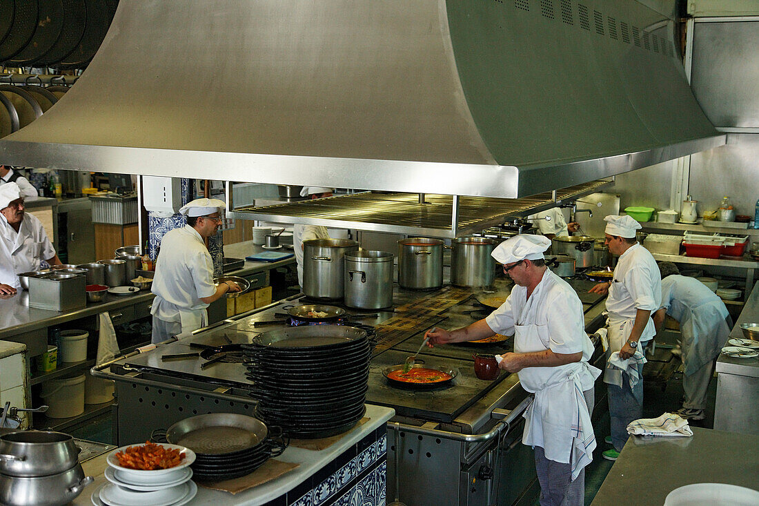 Cooks preparing paella, restaurant La Pepica, Province Valencia, Valencia, Spain