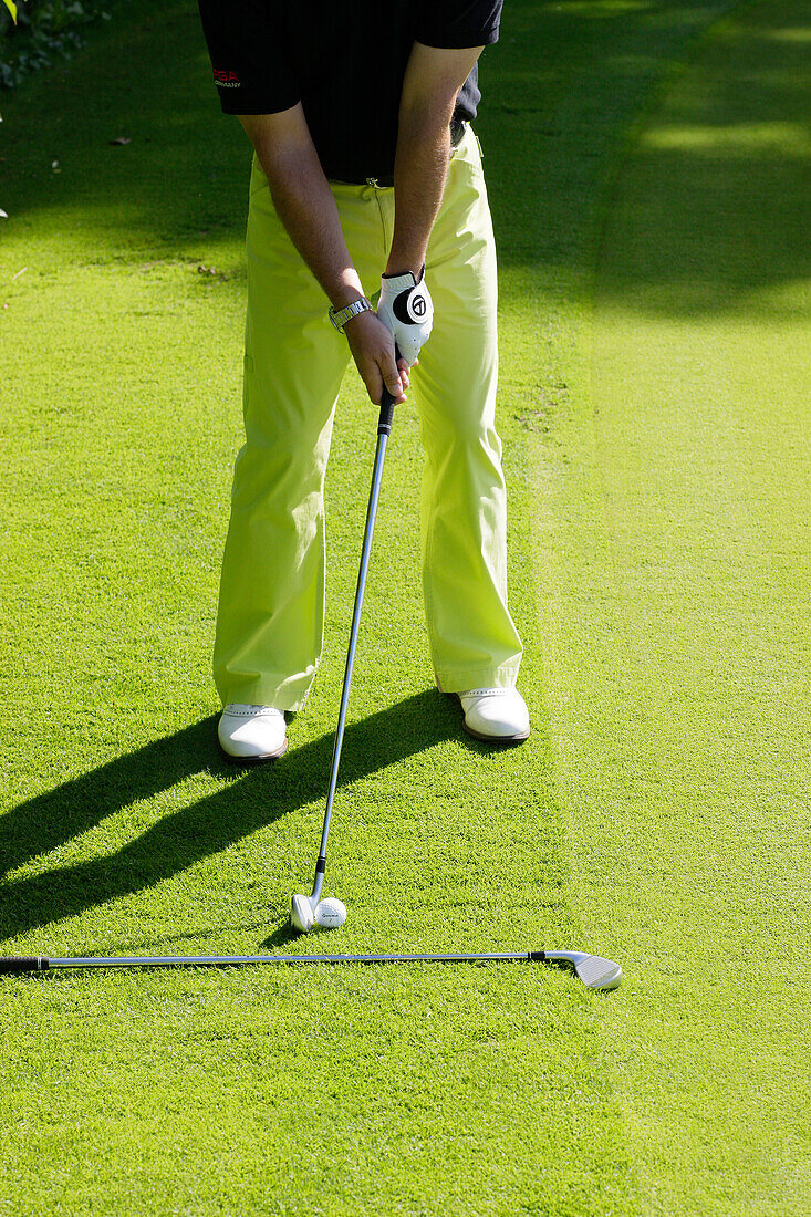 Man playing golf, Prien am Chiemsee, Bavaria, Germany