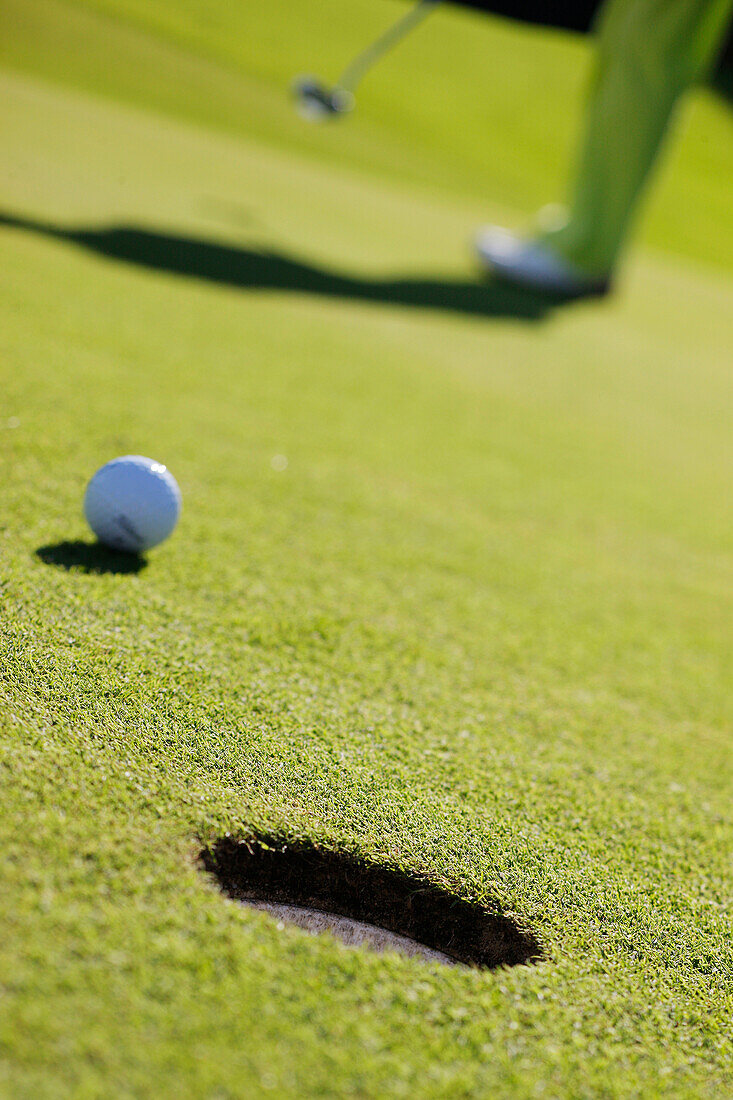 Golfspieler beim Einlochen, Prien am Chiemsee, Bayern, Deutschland