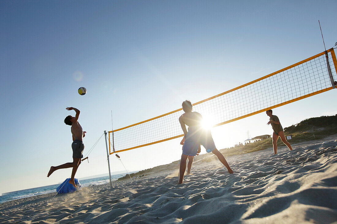 Men playing beach volleyball, Formentera, Balearic Islands, Spain