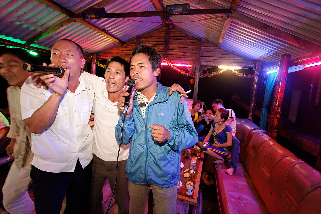 Men singing karaoke on a boat, Halong Bay, Quang Ninh, Vietnam