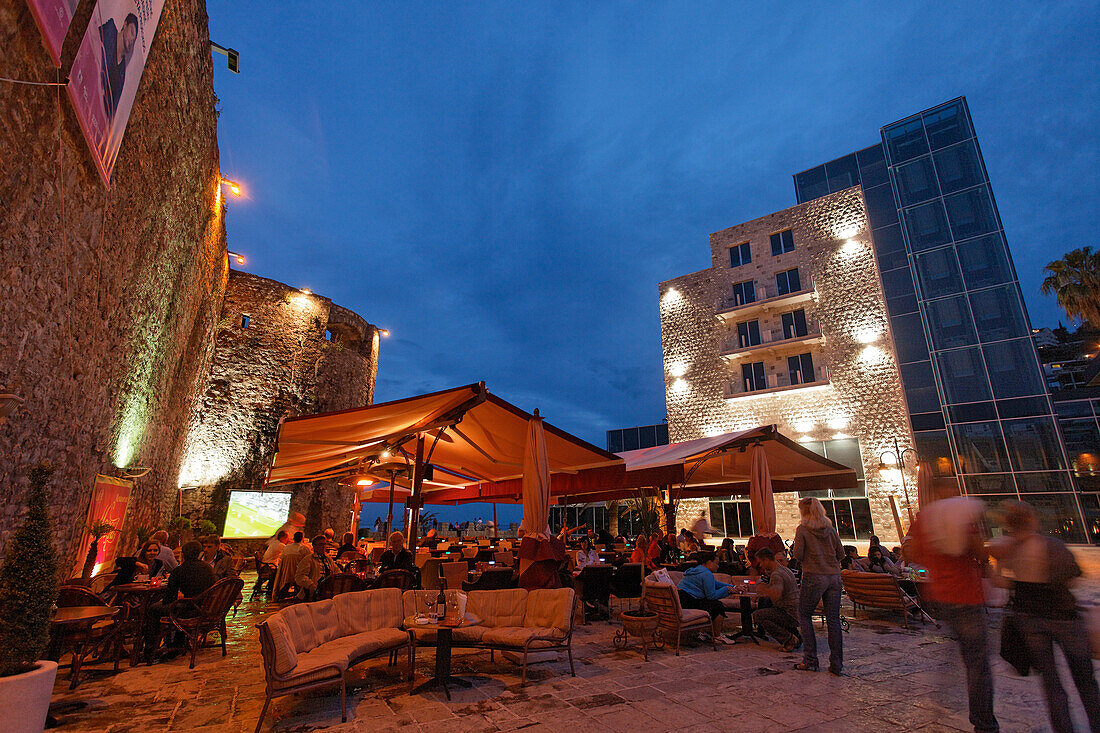 Restaurants at the city wall in the evening, Budva, Montenegro, Europe