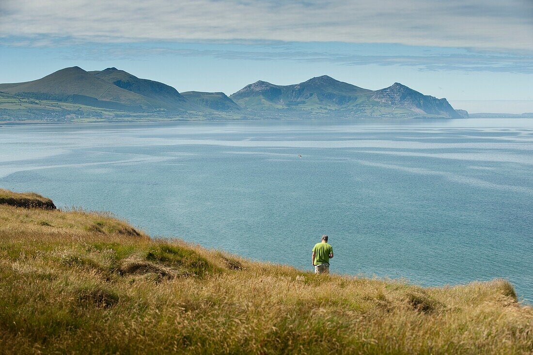 Looking towards Yr Eifl - The Rivals mountains, Summer morning, Dinas Dinlle beach on the north coast of the Lleyn Peninsula, Wales UK