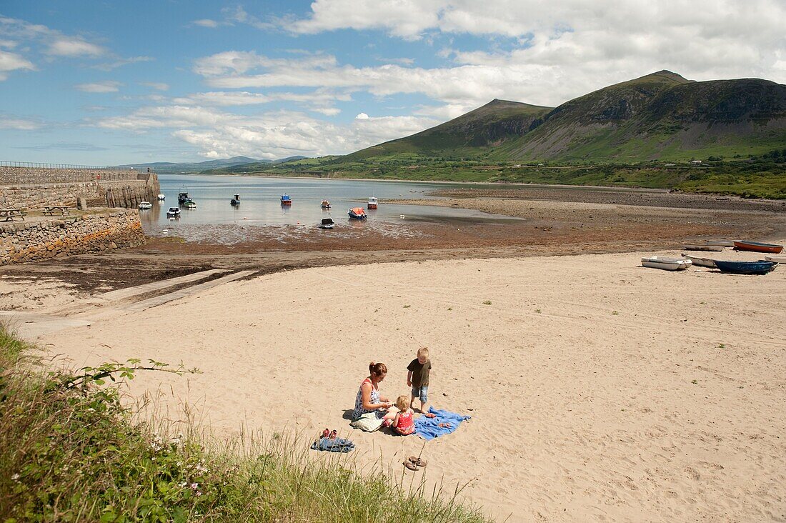 A young family on the beach at Trefor on the north coast of the Lleyn Peninsula, wales UK, summer afternoon