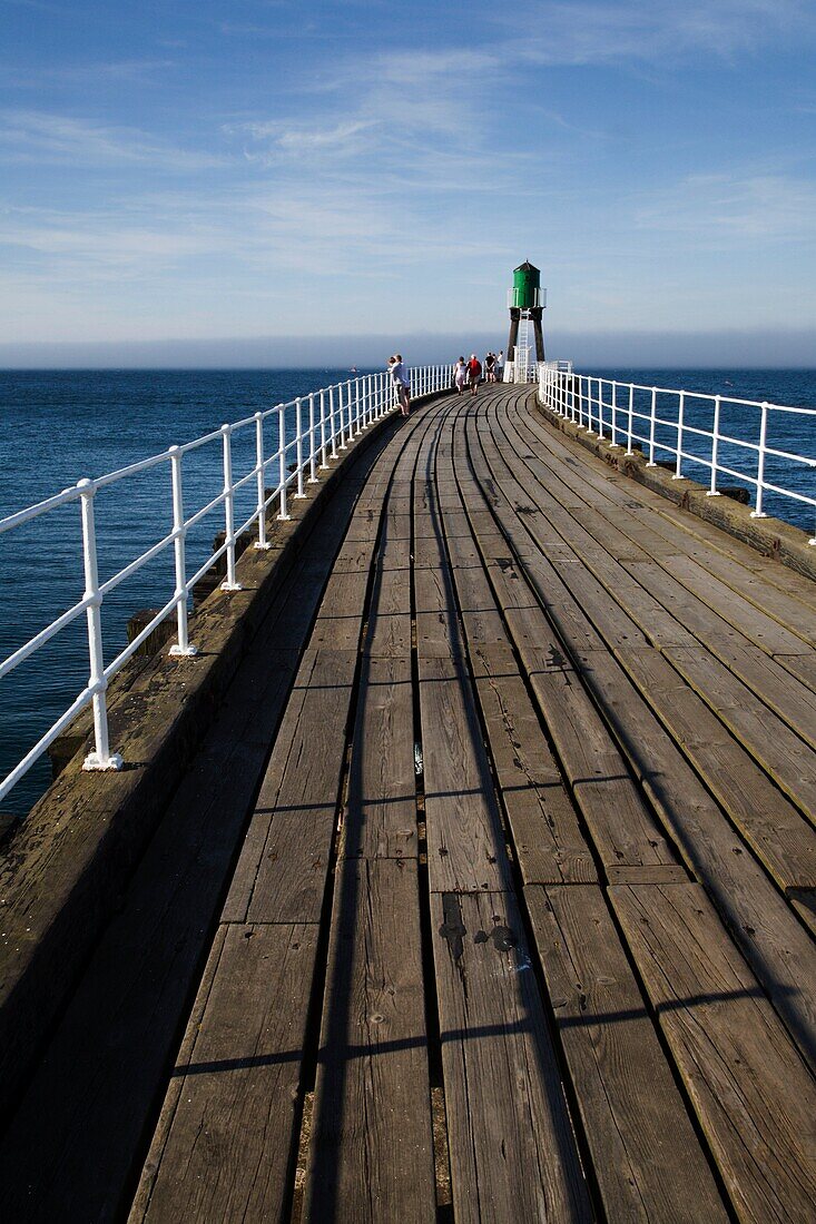 People Enjoying The View From The West Pier at Whitby North Yorkshire England