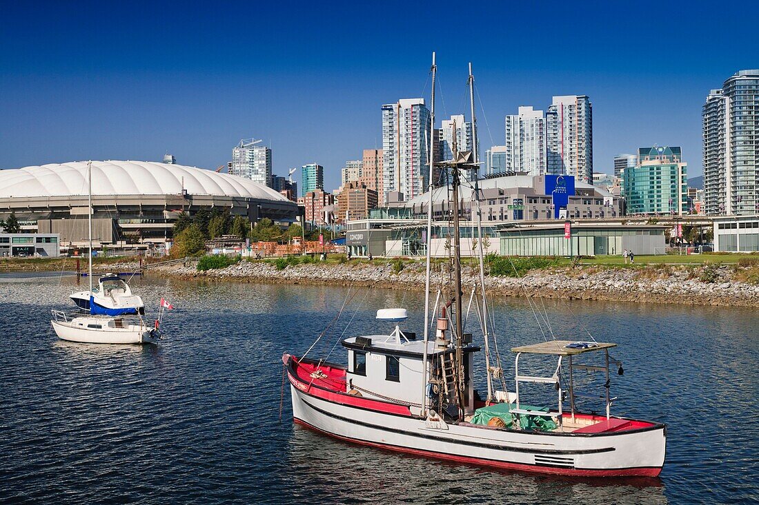 Ships in front of the BC Place Stadium and the skyline of Vancouver, British Columbia, Canada