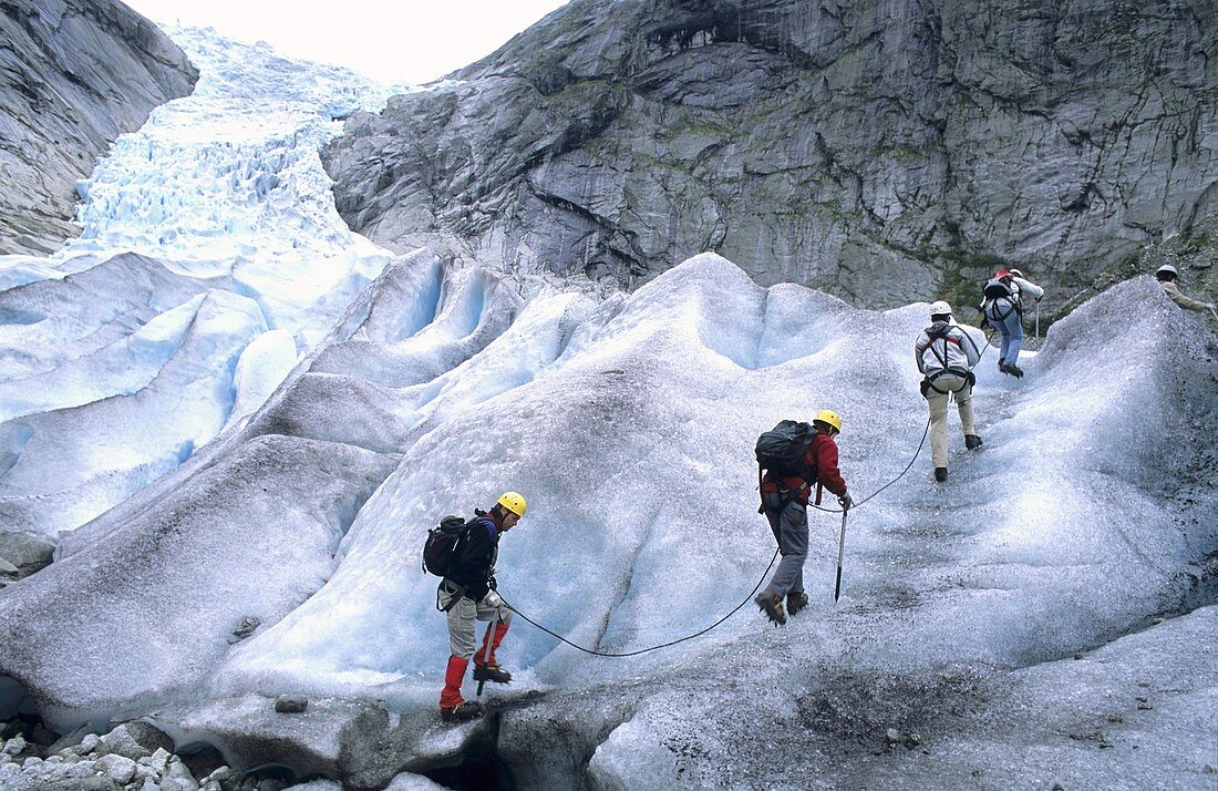 Tourists climb up Nigardsbreen glacier National Park of Jostedalbreen Norway