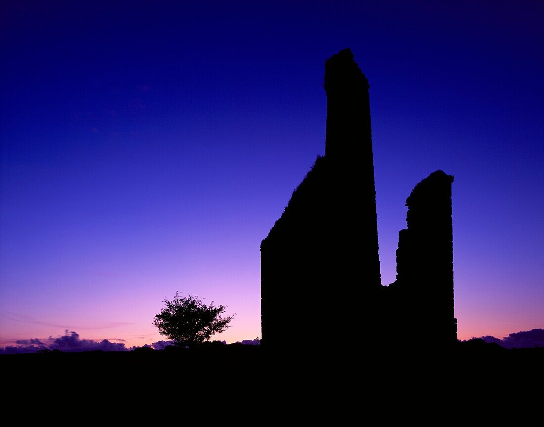 Silhouette of an old engine house ruin at the New Phoenix Mine, also known as the Silver Valley Mine, on Bodmin Moor, Minions, Cornwall, England, United Kingdom