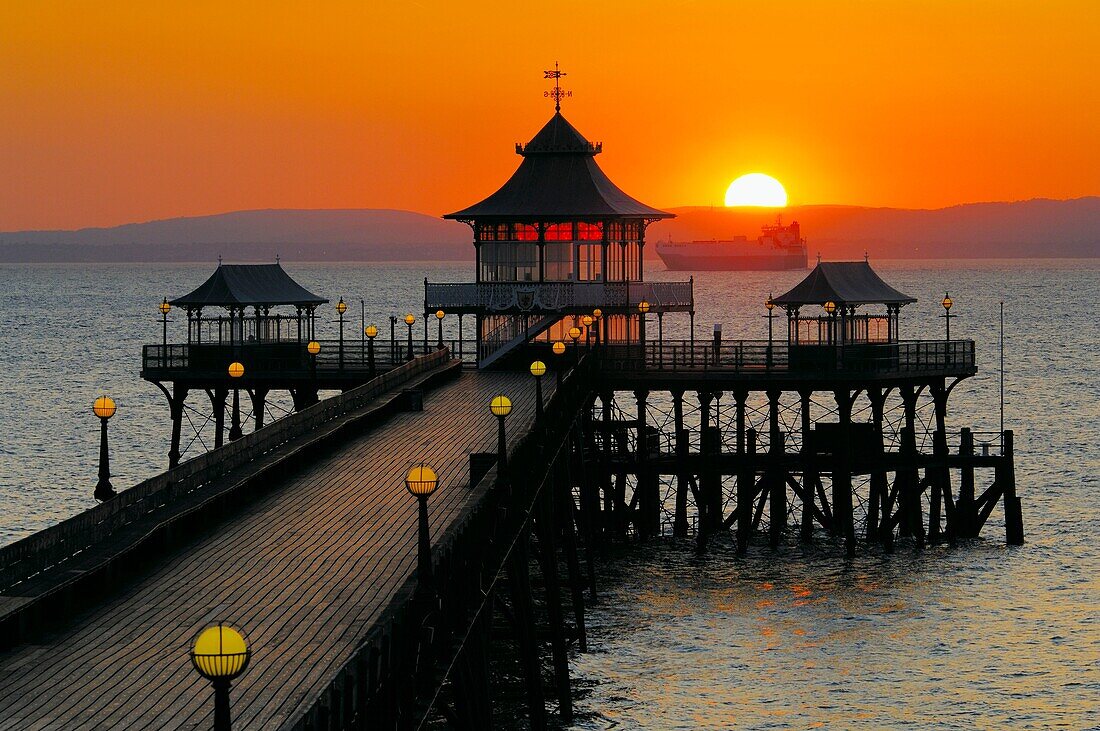 Sunset over the pier in the Bristol Channel at the seaside town of Clevedon in Somerset, England