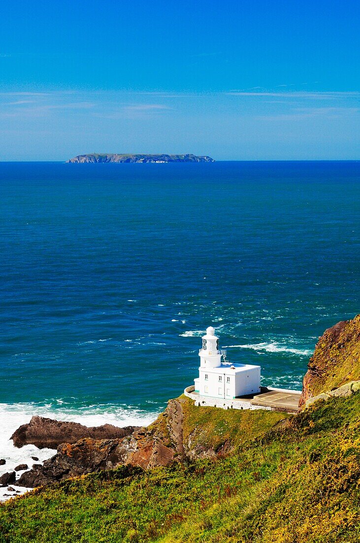 Hartland Point lighthouse on the North Devon Coast with Lundy Island on the horizon, England, United Kingdom