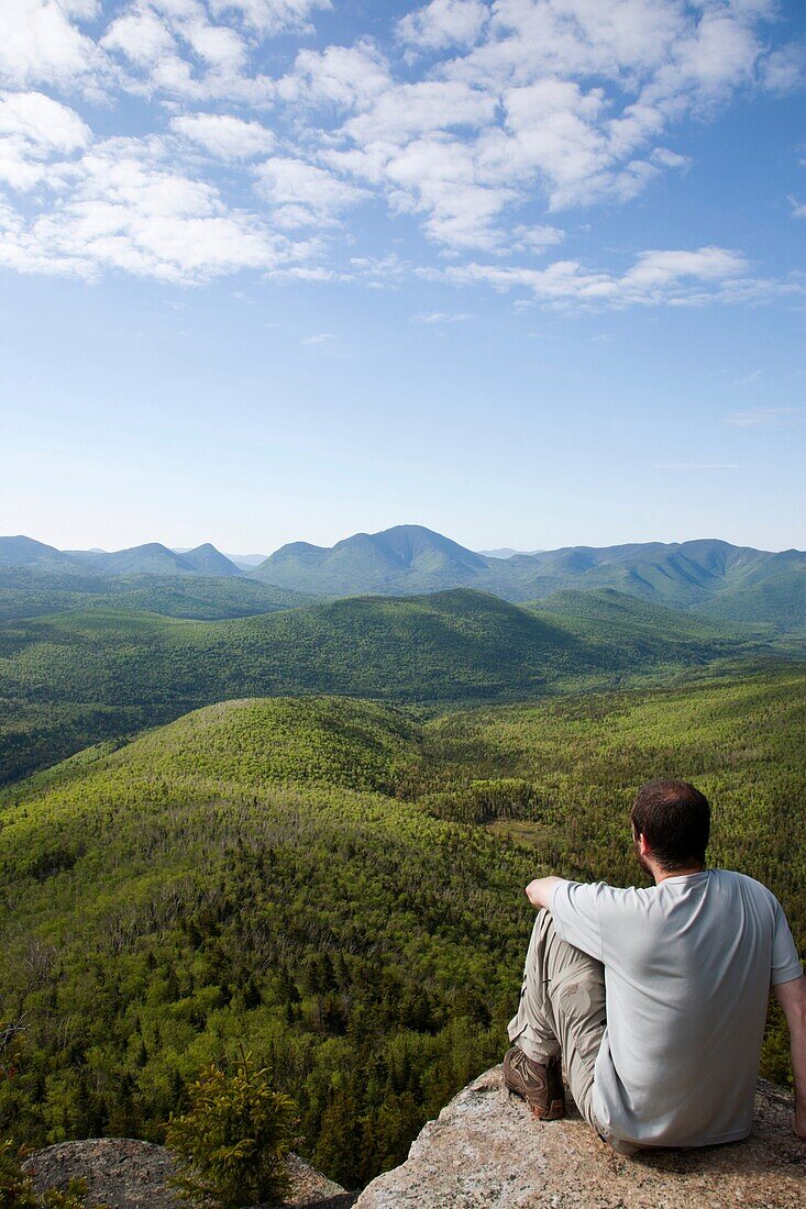 Zealand Notch - A hiker takes in the views from the summit of Zeacliff during the summer months Located along the Appalachian Trail in the White Mountains, New Hampshire USA