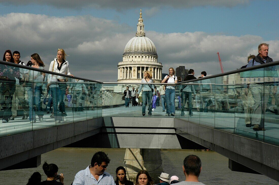 People walking on and below Millennium Bridge with St Paul’s Cathedral in the distance, London, England