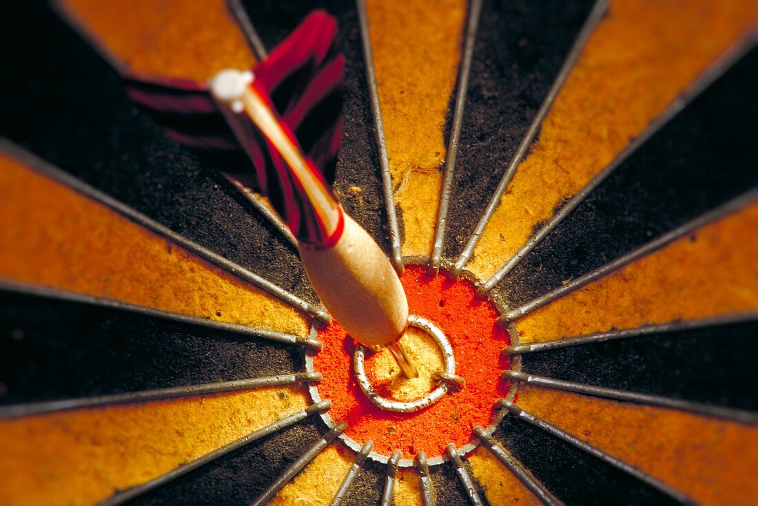 Dart in bulls eye of a dart board