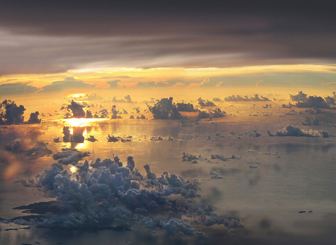 View from a plane over the sea of clouds on archipelagoes