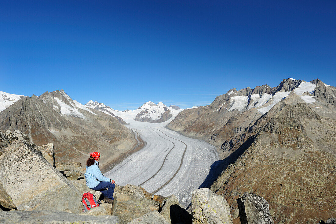 Woman looking towards glacier Grosser Aletschgletscher with Jungfrau, Moench, Eiger and Wannenhorn, Eggishorn, UNESCO World Heritage Site Swiss Alps Jungfrau - Aletsch, Bernese Alps, Valais, Switzerland, Europe