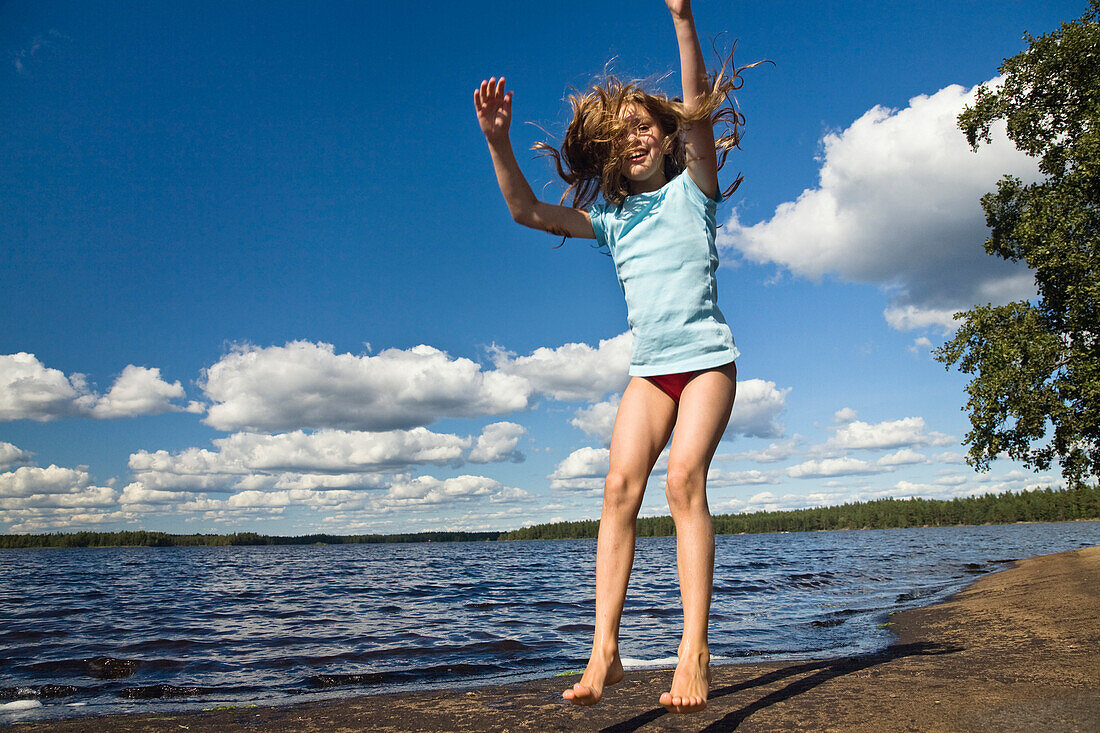 Nine Year Old Girl Jumping In The Air At … License Image 70340923