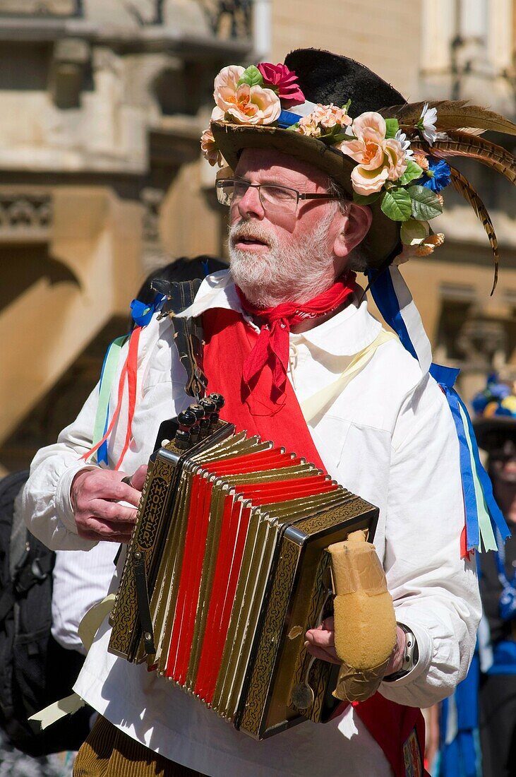 Morris musician playing dance tunes on a melodeon to accompany the morris dancing at the Oxford Folk festival