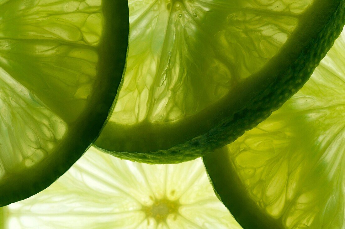 detail of overlapping slices of lime, lit from behind