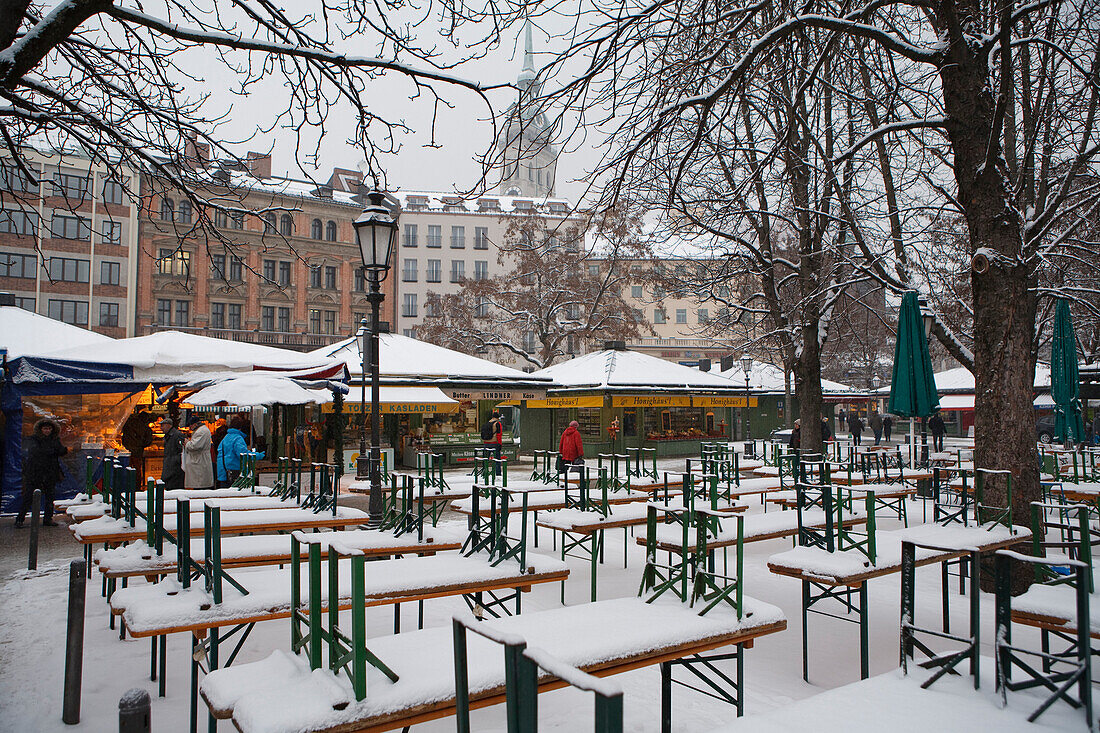 Snow-covered beer tables, Viktualienmarkt, Munich, Bavaria, Germany