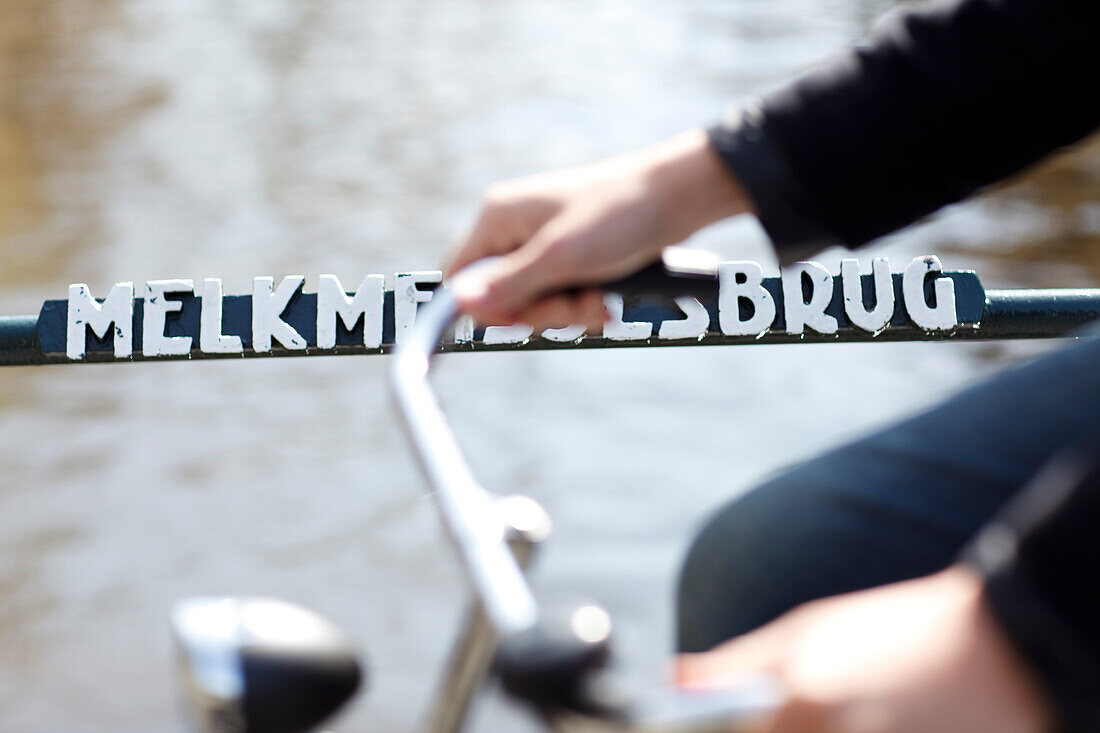 Detail of a cyclist on a bridge in Amsterdam, Netherlands