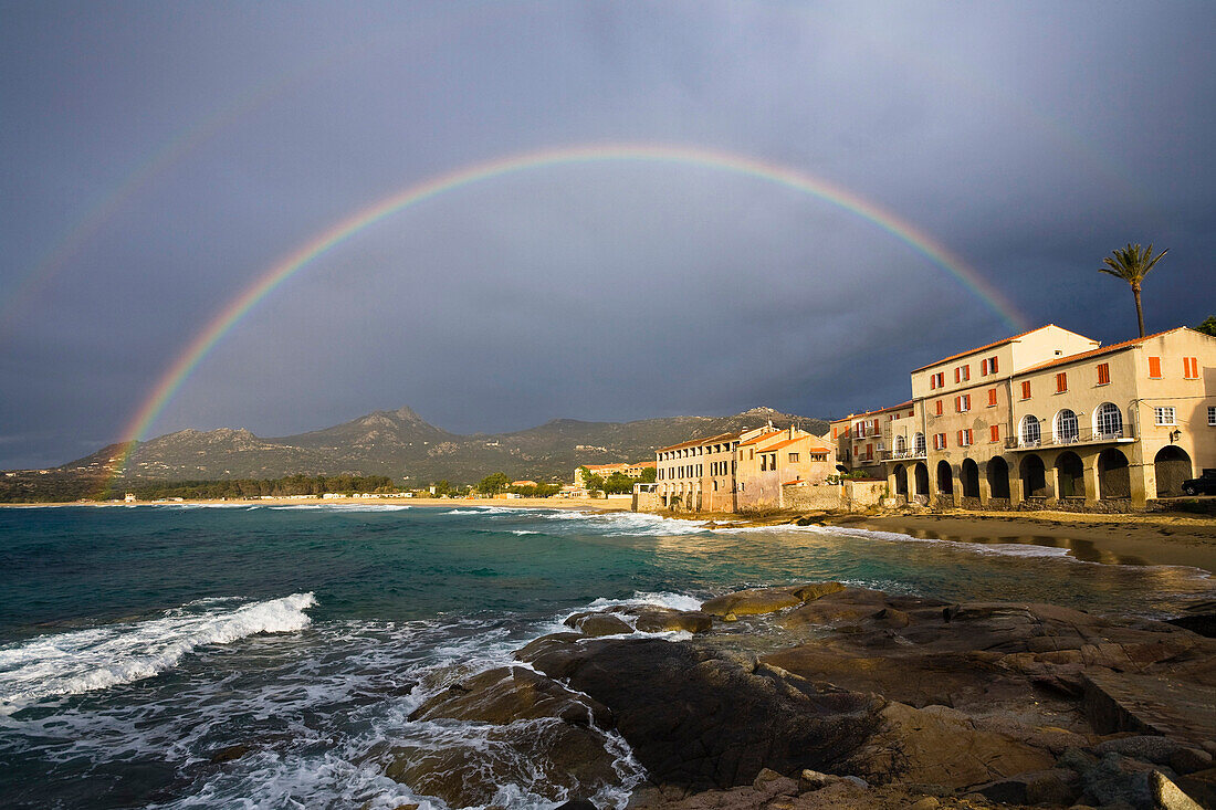 Coastal scenery with rainbow in the evening, Algajola Bay, Corsica, France