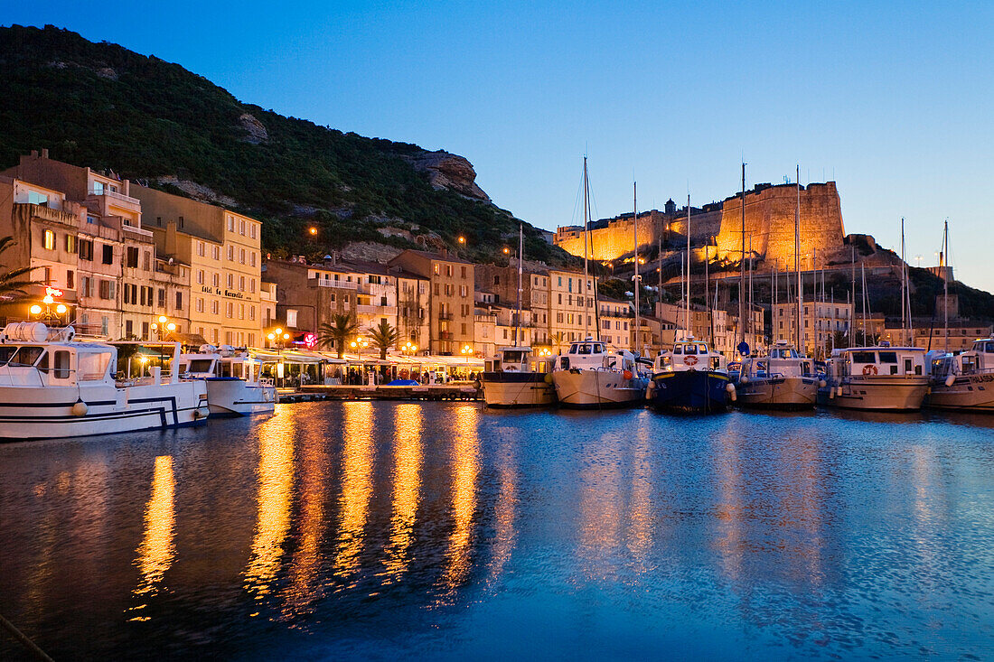 Bonifacio harbour with citadel at dusk, south coast, Corsica, France, Europe