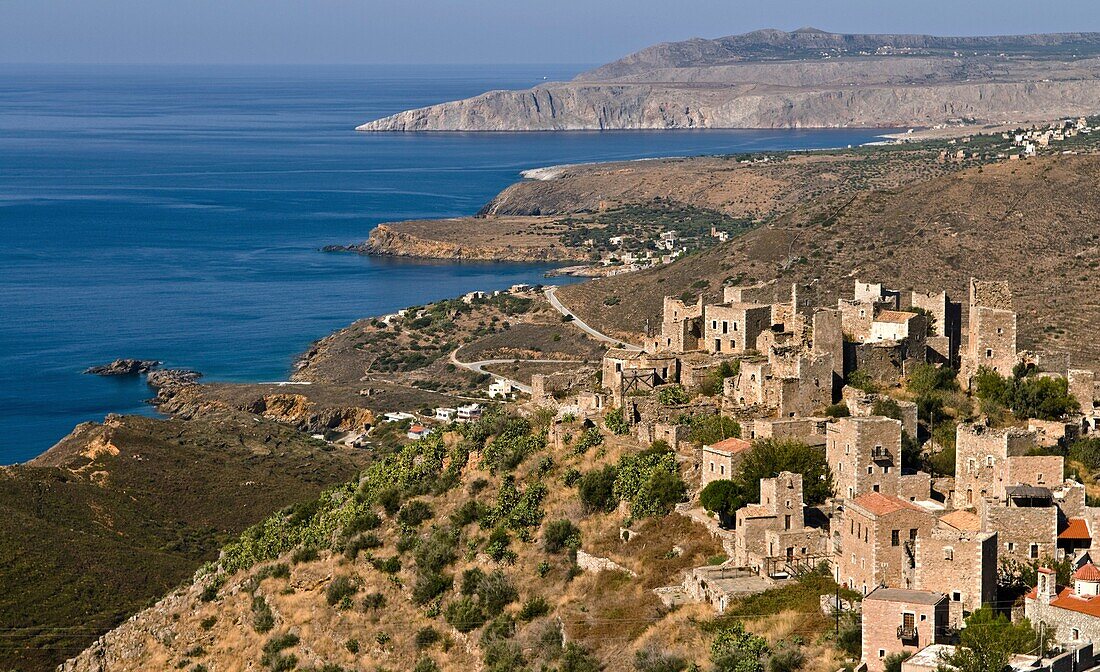 The village of Vathia with its many tower houses and the dramatic coast of the Deep Mani in the background, Southern peloponnese, Greece