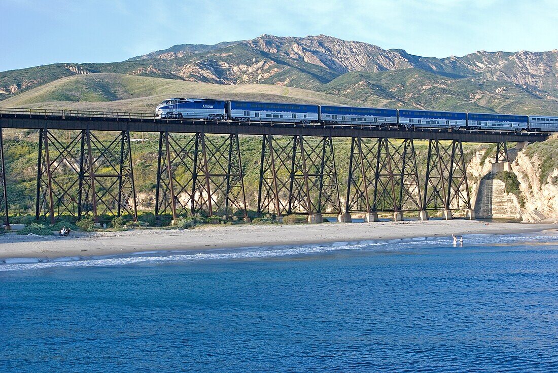 The Amtrak Pacific SurfLiner train on the Gaviota Trestle above Gaviota State Park on the Pacific Ocean in southern California USA